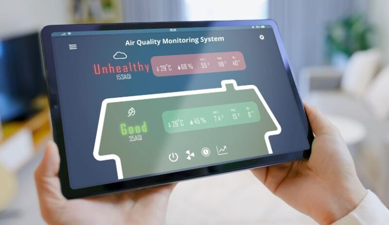 a person holding tab which has air quality monitoring data