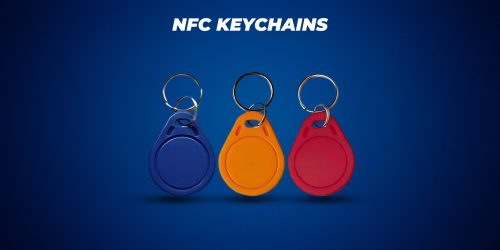 "NFC keychains in blue, orange, and red colors with metallic rings, displayed against a blue background.