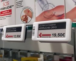 a pharmacy shelf with electronic shelf labels displaying prices.