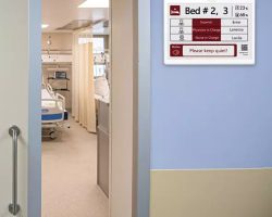 a hospital ward name plate with a digital smart label displaying bed details, staff information